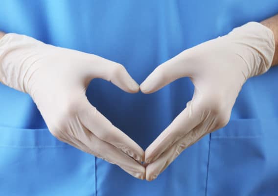 Doctor,Showing,Shape,Of,Heart,By,His,Hands,In,Sterile