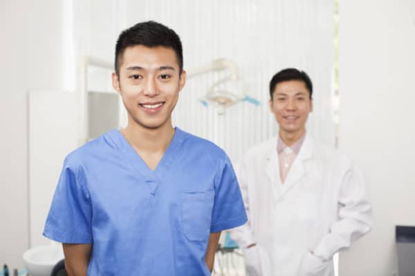 Portrait,Of,Smiling,Dental,Assistant,In,Clinic