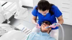 dentist treating patient teeth at dental clinic